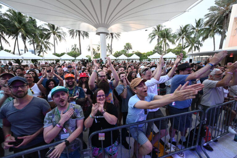 a crowd of people standing next to each other