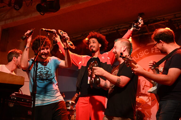 a group of men standing on top of a stage