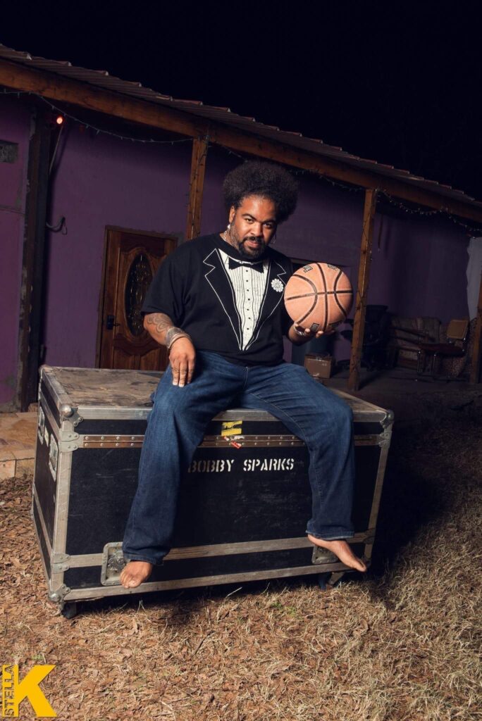 a man sitting on a trunk holding a basketball