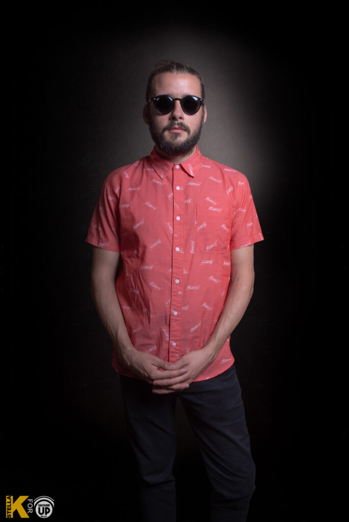 a man wearing sunglasses and a red shirt