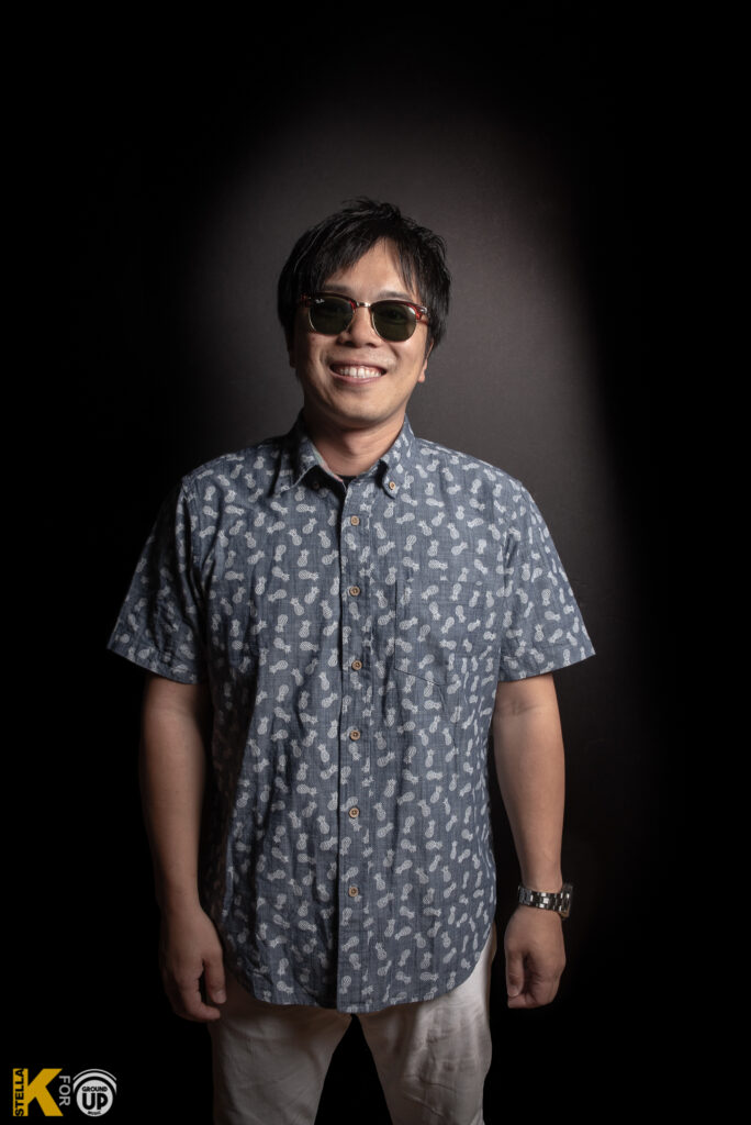 a man wearing sunglasses and a blue shirt