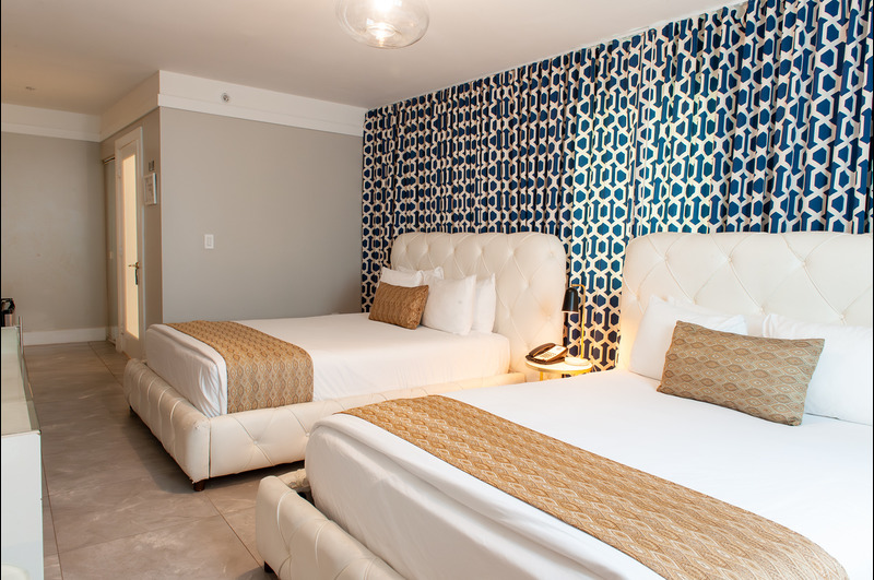 a couple of beds sitting next to each other in a bedroom